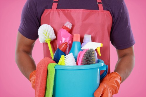Technician using carpet cleaning equipment on a home carpet