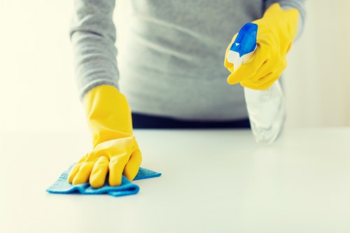 Tenant cleaning kitchen cupboards during end of tenancy cleaning