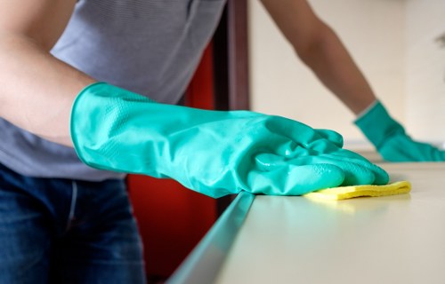 Technician assessing upholstery fabric before cleaning