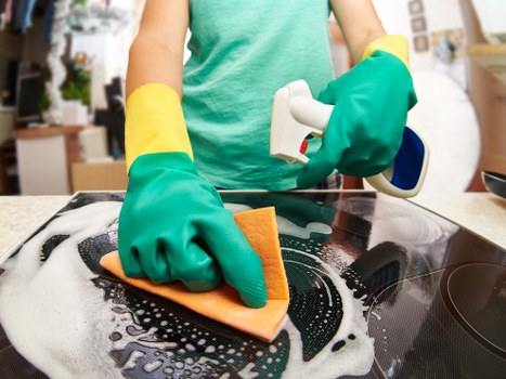 Kitchen surfaces being cleaned during domestic cleaning routine